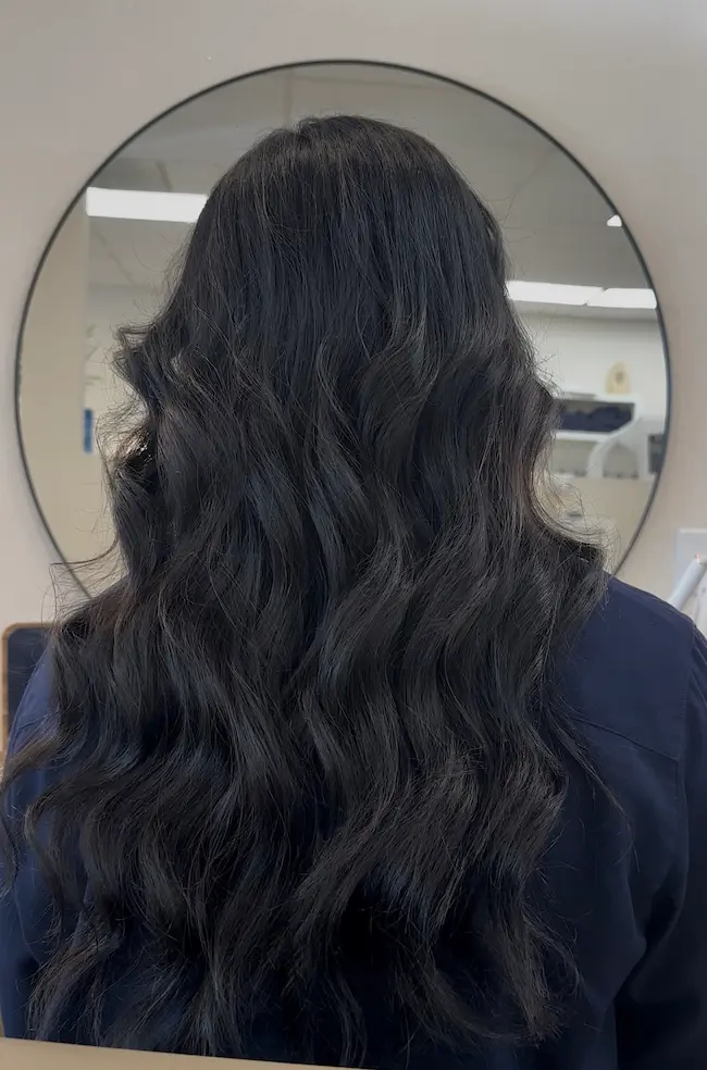 Rich dark brunette all-over hair color with soft waves