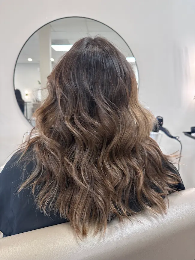 Rich brunette base color with soft caramel dimension