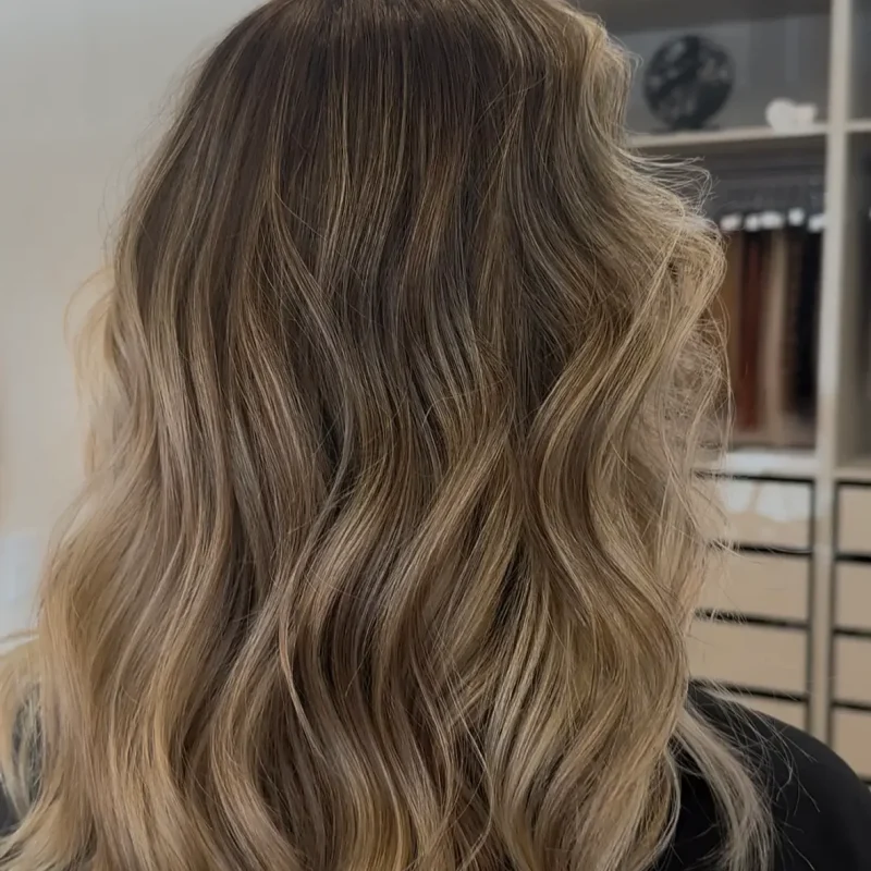 Soft blonde balayage with blended dimension and waves