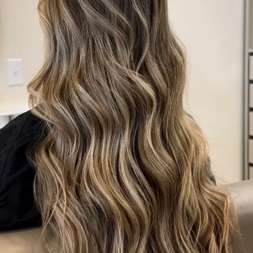 Long dimensional blonde balayage with soft waves