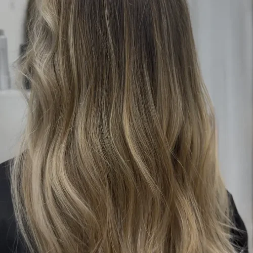 Dimensional blonde balayage with soft blended waves