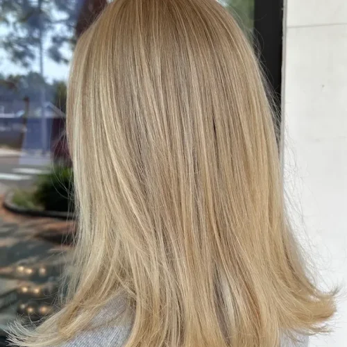Bright blonde full highlight with soft layered ends