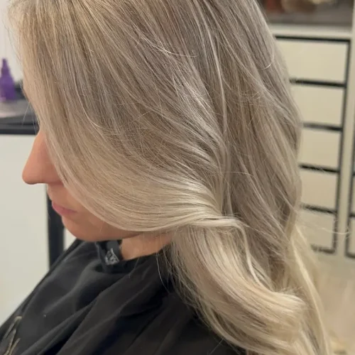 Cool blonde full highlight with soft waves at Anna Hair Studio