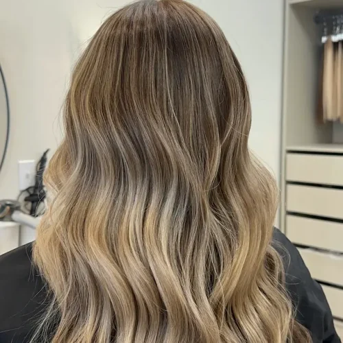 Dimensional blonde balayage with soft waves at Anna Hair Studio